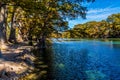 Bright Beautiful Fall Foliage on the Crystal Clear Frio River Royalty Free Stock Photo