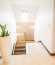 Bright beautiful, modern home interior with natural light. Corridor with a wooden stairs Royalty Free Stock Photo