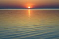 Bright beautiful sunset at the calm sea. Solar disk over water. Royalty Free Stock Photo