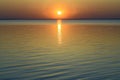 Bright beautiful sunset at the calm sea. Solar disk over water. Royalty Free Stock Photo