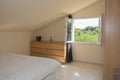 Bright Bedroom in attic with big bed Royalty Free Stock Photo