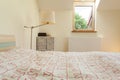 Bright bedroom with small window Royalty Free Stock Photo