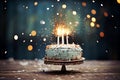 Bright birthday cake with sparkling candles and colorful confetti for a festive dessert. Copy space