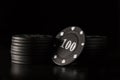 Bright black poker chips on a dark background Royalty Free Stock Photo