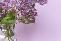 Bright blooms of spring lilacs on a table in house. Spring purple flowers close-up. Selected focus
