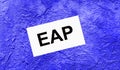 On a bright blue abstract background, there is a white card with the text EAP Employee Assistance Program Royalty Free Stock Photo