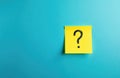 Bright blue background features yellow sticky note with question mark. Image inquiry uncertainty, brainstorming. Represents Royalty Free Stock Photo