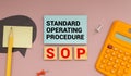 On a bright blue background, light wooden blocks and cubes with the text SOP Standard Operating Procedure Royalty Free Stock Photo