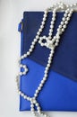 Blue bag and white pearl beads on a white background. Royalty Free Stock Photo