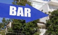 Bright Blue Bar Sign Directing Patrons to the Local Watering Hole