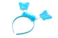 Bright blue children`s headband for girl with butterflies on springs and decorated with feathers isolated on white