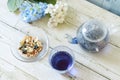 Bright blue color butterfly pea flower herb tea in a glass teapot and a cup Royalty Free Stock Photo