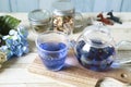 Bright blue color butterfly pea flower herb tea in a glass teapot and a cup Royalty Free Stock Photo