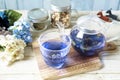 Bright blue color butterfly pea flower herb tea in a glass teapot and a cup Royalty Free Stock Photo