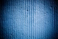 Bright blue color cement coarse facade wall with grooves as an empty rustic surface texture background with vignetting Royalty Free Stock Photo