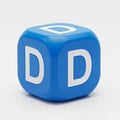 Blue Cube with White Letter D on Three Visible Sides on a Light Gray Background alphabet Royalty Free Stock Photo