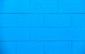 Bright blue exterior brick wall on the side of a building