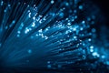 Bright blue fiber optic strands extend outward in a dark environment, creating a stunning visual effect. This vibrant light Royalty Free Stock Photo