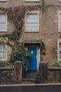 Bright blue front door on a traditional stone terraced house in Frome, UK