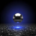 A bright blue glow emanating from beneath the sphere creating a Royalty Free Stock Photo