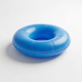 Blue Inflatable Ring Floating on White Surface swimming ring pool float Royalty Free Stock Photo