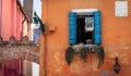 Bright Blue Italian Window With Canary Cage hanging In It