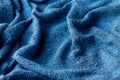 Bright blue knitted fabric texture. Crumpled blanket background Royalty Free Stock Photo