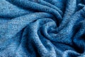 Bright blue knitted fabric texture. Crumpled twisted blanket background Royalty Free Stock Photo