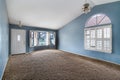 Bright Blue large empty room with carpet floor, molding and windows. Royalty Free Stock Photo