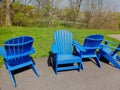 bright blue lawn chairs sitting out by grass for people to sit and rest