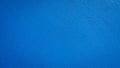Bright blue painted wall texture background, rough surface detail, copy space. Royalty Free Stock Photo