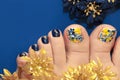 Bright blue pedicure with a design of butterflies
