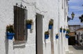 Bright blue plant-pots with Geraniums on white-washed houses, Spain Royalty Free Stock Photo