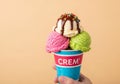 A bright blue and red cup labeled CREM containing three scoops of Royalty Free Stock Photo