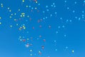 Bright blue, red and yellow air balloons rise up in the blue sky. Balls background Royalty Free Stock Photo