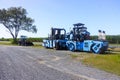 Bright blue road construction machinery parked