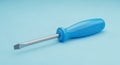 Bright Blue Screwdriver with a Flat Head on a Light Blue Background tool flathead Royalty Free Stock Photo