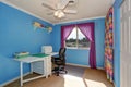 Bright blue sewing room interior with colorful curtains. Royalty Free Stock Photo