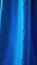 Bright blue silk curtain, sharp spotlight beam, studio, event Royalty Free Stock Photo