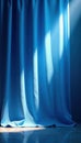 Bright blue silk curtain, sharp spotlight beam, texture, light, background Royalty Free Stock Photo