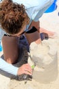 Young woman carving windows into her sandcastle, Orange Beach, Alabama, 2018 Royalty Free Stock Photo
