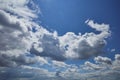 Bright blue of the sky with beautiful cumulus clouds illuminated by the sun at its zenith Royalty Free Stock Photo