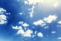 Bright blue sky with clouds with the rays of the sun. Background. Space for text Royalty Free Stock Photo