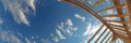 Construction of a Wooden Framework Under a Bright Blue Sky With Scattered Clouds During Daytime Royalty Free Stock Photo
