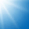 A bright blue sky with soft, white sun rays radiating from the top left corner, creating a Royalty Free Stock Photo