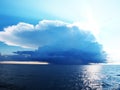 Bright blue sky with stormy clouds over a sea Royalty Free Stock Photo