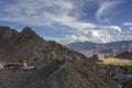 A bright blue sky with white clouds in the mountains above the village Royalty Free Stock Photo