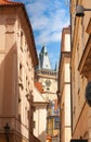 See in old town the old clock tower. You are viewing from a narrow side street of medieval buildings.