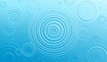 Blue water surface with concentric ripples and small droplets Royalty Free Stock Photo