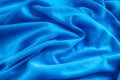 Bright blue wrinkled fabric texture background